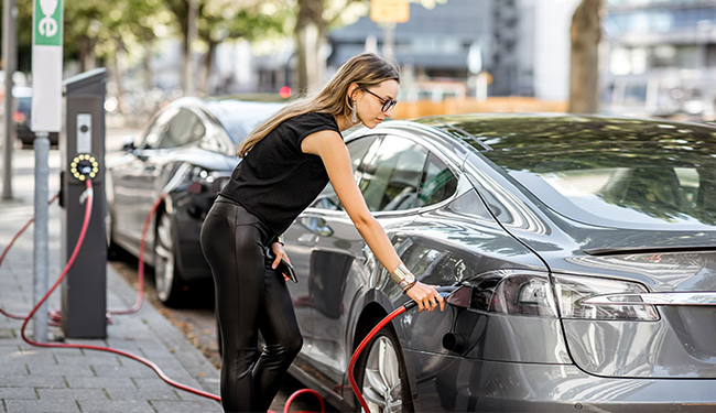 woman charging EV car